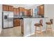 Kitchen with stainless steel appliances, a breakfast bar, and lots of wooden cabinet space at 3471 Julius Estates Blvd, Winter Haven, FL 33881
