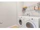 Functional laundry room includes white washer and dryer at 3471 Julius Estates Blvd, Winter Haven, FL 33881