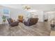 Spacious living room featuring wood-look tile floors and bright, natural light at 3471 Julius Estates Blvd, Winter Haven, FL 33881