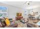Bright and airy living room featuring a ceiling fan, tile floors, and lots of natural light at 3471 Julius Estates Blvd, Winter Haven, FL 33881