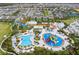 Aerial view of a water park with colorful slides, swimming pools, and a lazy river surrounded by lush landscaping at 385 Southfield St, Kissimmee, FL 34747