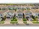 An aerial view shows the community homes with well manicured lawns and paver driveways at 385 Southfield St, Kissimmee, FL 34747
