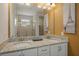 Bright bathroom featuring a double sink vanity with granite countertops and decorative painting at 385 Southfield St, Kissimmee, FL 34747