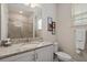 Bright bathroom featuring granite countertop vanity, framed mirror, toilet and walk-in shower at 385 Southfield St, Kissimmee, FL 34747
