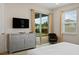 Bedroom featuring sliding glass doors, a dresser, and neutral decor with a view of the pool at 385 Southfield St, Kissimmee, FL 34747