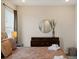 Comfortable bedroom featuring dresser, soft bedding, and lots of natural light from the window at 385 Southfield St, Kissimmee, FL 34747