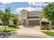 Charming two-story home with a paved driveway leading to an attached two-car garage at 385 Southfield St, Kissimmee, FL 34747