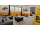 Inviting game room with a large sofa, arcade games, and bright decor for Gathering fun at 385 Southfield St, Kissimmee, FL 34747