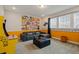 Fun game room with arcade game, a comfortable couch and movie themed decorations at 385 Southfield St, Kissimmee, FL 34747