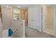 Long hallway with carpet, doors and wall decorations at 385 Southfield St, Kissimmee, FL 34747