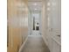Long hallway with tan walls, with wall decorations and white doors at 385 Southfield St, Kissimmee, FL 34747