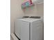 Modern laundry room with white front-loading washer and dryer, and plenty of storage space at 385 Southfield St, Kissimmee, FL 34747