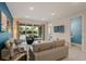 Inviting living room featuring modern decor, tile floors, and sliding glass doors leading to the outdoor area at 385 Southfield St, Kissimmee, FL 34747