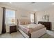 Relaxing main bedroom with plush bedding, accent pillows and neutral decor at 385 Southfield St, Kissimmee, FL 34747