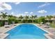 Backyard pool area with lounge chairs and mature landscaping, perfect for enjoying the outdoors at 385 Southfield St, Kissimmee, FL 34747