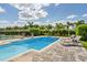 Backyard pool area with lounge chairs and mature landscaping, perfect for enjoying the outdoors at 385 Southfield St, Kissimmee, FL 34747