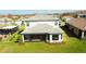 Home exterior featuring backyard, screened in patio and lush lawn at 3920 Reed Grass Pl, Kissimmee, FL 34746