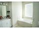 Bathroom featuring a soaking tub, vanity and natural light at 3920 Reed Grass Pl, Kissimmee, FL 34746
