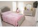 Bedroom featuring carpet flooring, neutral walls, modern dresser and large bed at 3920 Reed Grass Pl, Kissimmee, FL 34746