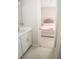 View into bedroom from ensuite bathroom, bedroom features carpet flooring and neutral paint at 3920 Reed Grass Pl, Kissimmee, FL 34746