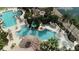 Aerial view highlights the community pool area with its waterslide and plenty of lounge chairs at 3920 Reed Grass Pl, Kissimmee, FL 34746