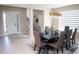 Elegant dining room with modern chandelier, stylish furniture, and a view of the staircase and front entrance at 3920 Reed Grass Pl, Kissimmee, FL 34746