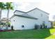 Two-story home with neutral tones, well-maintained landscaping, and a tiled roof adds to its curb appeal at 3920 Reed Grass Pl, Kissimmee, FL 34746