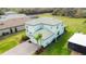 Aerial view of the home showcasing its tile roof, backyard space, and proximity to neighboring properties at 3920 Reed Grass Pl, Kissimmee, FL 34746