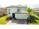 Charming two-story home featuring a two-car garage, neutral paint, tile roof, and well-manicured landscaping at 3920 Reed Grass Pl, Kissimmee, FL 34746
