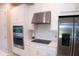 Modern kitchen features stainless steel appliances, white cabinets, stylish hardware and tile backsplash at 3920 Reed Grass Pl, Kissimmee, FL 34746