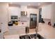 Bright kitchen with stainless steel appliances, white subway tile backsplash and quartz countertops at 3920 Reed Grass Pl, Kissimmee, FL 34746