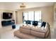 Living room featuring a plush sofa, contemporary furniture, and access to outdoor space at 3920 Reed Grass Pl, Kissimmee, FL 34746
