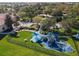 Community playground with covered play structures, picnic tables, and green space in a well-maintained area at 3920 Reed Grass Pl, Kissimmee, FL 34746