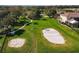 Aerial shot of a community volleyball court next to a swing set and a walking path with ample green space at 3920 Reed Grass Pl, Kissimmee, FL 34746