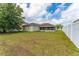 Expansive backyard with a screened-in patio and a privacy fence, perfect for outdoor entertaining at 502 Woodland Creek Blvd, Kissimmee, FL 34744