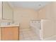 Bathroom with tiled floors, a tub, and a vanity with a sink and faucet at 502 Woodland Creek Blvd, Kissimmee, FL 34744