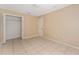 Neutral bedroom with tiled floor and closet at 502 Woodland Creek Blvd, Kissimmee, FL 34744