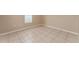 Neutral bedroom with tile flooring and natural light from the window at 502 Woodland Creek Blvd, Kissimmee, FL 34744