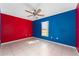 Colorful bedroom with tile floors, ceiling fan, and window at 502 Woodland Creek Blvd, Kissimmee, FL 34744