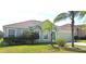 Charming single-story home with a well-maintained lawn, lush landscaping, and a two-car garage at 502 Woodland Creek Blvd, Kissimmee, FL 34744