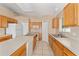 Spacious kitchen featuring dual sinks, an island, and plentiful cabinet storage space at 502 Woodland Creek Blvd, Kissimmee, FL 34744