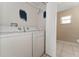 Laundry area featuring modern appliances and convenient access to the bathroom at 502 Woodland Creek Blvd, Kissimmee, FL 34744