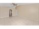 Bright living room with tile flooring, neutral walls, arched doorways, and a ceiling fan at 502 Woodland Creek Blvd, Kissimmee, FL 34744