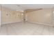 Bright and airy living room offering ample space, neutral tile floors, and arched architectural details at 502 Woodland Creek Blvd, Kissimmee, FL 34744