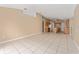 Spacious living room that opens to a kitchen area with tiled flooring throughout at 502 Woodland Creek Blvd, Kissimmee, FL 34744