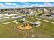 Aerial view showcasing a park area with picnic tables, a playground, and walking paths at 541 Jerry Ln, Haines City, FL 33844