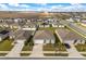 Aerial view showing houses with well-kept lawns, driveways, and partial solar panel roofs at 541 Jerry Ln, Haines City, FL 33844