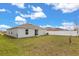 Well-maintained backyard featuring green grass, a white fence, and sliding glass door at 541 Jerry Ln, Haines City, FL 33844