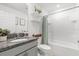 Bathroom featuring granite countertops, decor shelves and a tub with shower at 541 Jerry Ln, Haines City, FL 33844