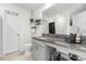 Bathroom with granite countertops, a decorative mirror, and a white toilet and door at 541 Jerry Ln, Haines City, FL 33844